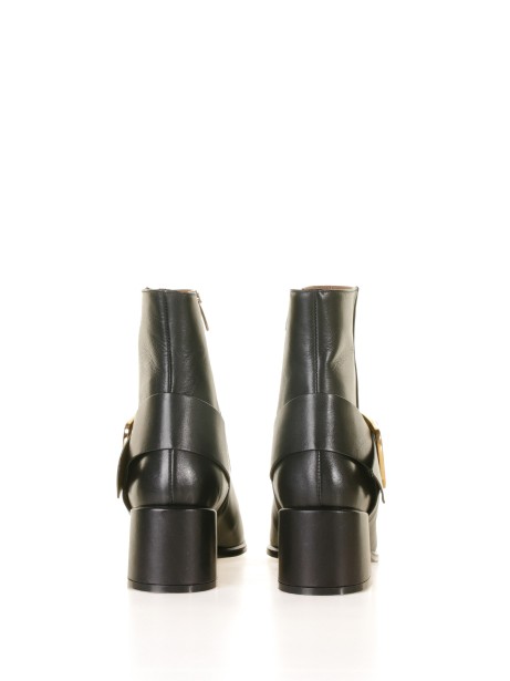 Leather ankle boot with golden buckle