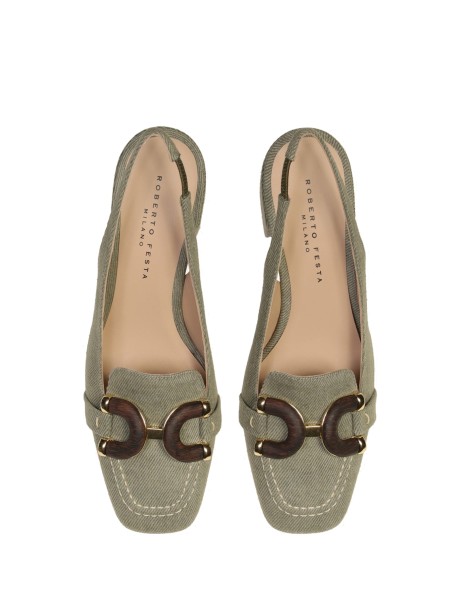 Chanel slingback in khaki jeans with wooden accessory